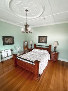 a bedroom with a bed and a chandelier at Stella's Dromana Hotel in Dromana