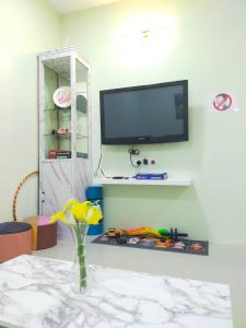 a living room with a tv on a wall at Octopus House Langkawi Easy Shop Easy Play in Kuah