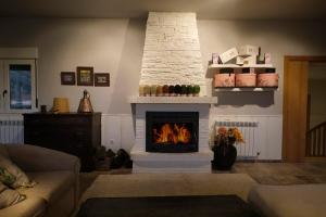 a living room with a fireplace in a room at CASA RURAL "LA MAZA" entre encinas y dehesas in Terradillos