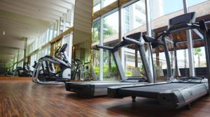 a gym with several cardio machines in a building at Apartment Podomoro City Deli Medan in Medan