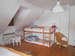 a room with a bunk bed in the attic at Chata Kolmanovci in Oščadnica