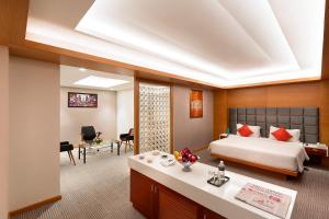 a hotel room with a bed and a desk at CJ Pallazzio,Salem in Salem