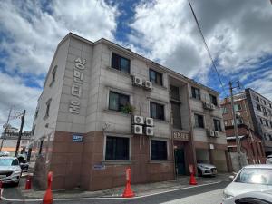 a building on a street with orange cones in front of it at Sangmin Sweet in Daejeon