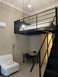 a room with a loft bed and a table and a bed at Kentrikon in Chalkida