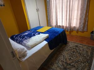 Un dormitorio con una cama con una manta azul. en WAMPEX GUEST HOUSE IN NORTHAM CBD 239 COAL STREET, en Northam