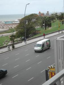 a van driving down a road next to the ocean at Mar Del Plata Loft in Mar del Plata