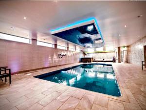 a large swimming pool in a large room at Sandpearl Suite Apartments in Lytham St Annes