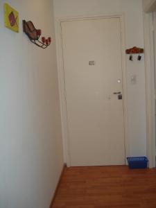 a room with a white door and a wooden floor at Mar Del Plata Loft in Mar del Plata