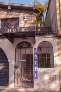 a building with a hotel sign on the front of it at Hotel Palma De Sevilla in Medellín