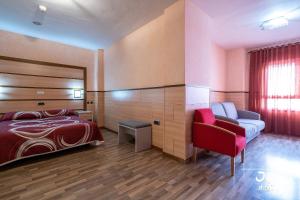 a hotel room with a bed and a couch at Hotel Pio XII Jumilla in Jumilla