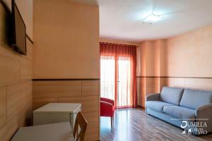 a living room with a blue couch and a table at Hotel Pio XII Jumilla in Jumilla