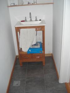 a bathroom with a sink and a table with a towel at Mar Del Plata Loft in Mar del Plata +3 photos