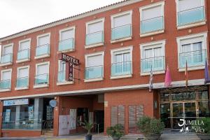 - un bâtiment en briques rouges avec un hôtel dans l'établissement Hotel Pio XII Jumilla, à Jumilla