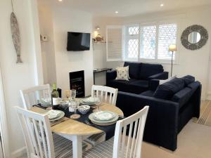 a living room with a table and a couch at Suncroft in Port Isaac