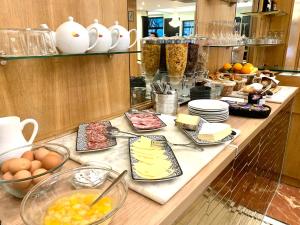 a counter with many different types of food on it at Hotel Le Clery in Paris