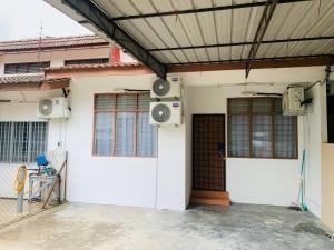 a house with two speakers on the side of it at Spar Homestay 2 in Kota Bharu