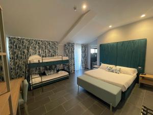 a bedroom with two bunk beds in a room at Hotel Sant'Elia in SantʼElia Fiumerapido