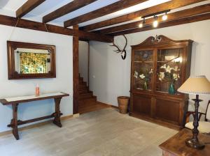 - un salon avec une table et une armoire en bois dans l'établissement Viviendas Rurales El Covaju, à Cabezón de Liébana