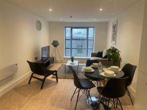 a living room with a table and chairs at stylish modern one bed Apartment in Birmingham