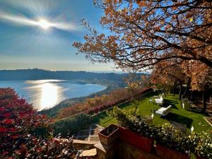 a view of a body of water with the sun at La Locanda Del Pontefice - Luxury Country House in Castel Gandolfo
