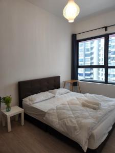 a bedroom with a large bed and a large window at Cozy 2BR APT @Ampang Embassy Row in Kuala Lumpur +33 photos