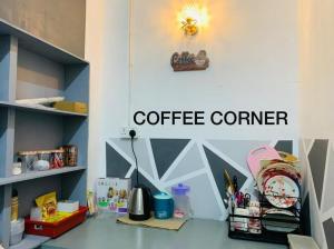 a coffee corner with a sign on a wall at Spar Homestay in Kota Bharu +3 photos