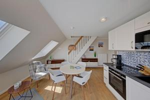 a kitchen and living room with a table and chairs at Endlich Theda in Juist