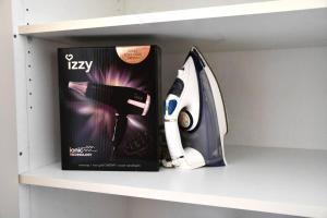 a book and a scissors and a box on a shelf at Sitos Home Spacious Family Home in Sparta