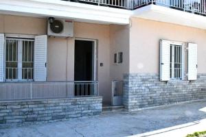 a building with white windows and a balcony at Sitos Home in Sparti