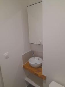 a bathroom with a white sink and a toilet at Appartement Duplex 8 personnes proche télécabines in Ax-les-Thermes