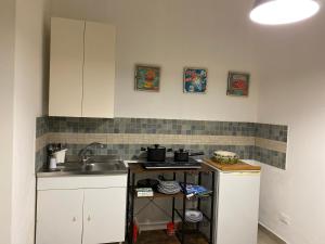 a small kitchen with a sink and a stove at Da Rosina in Palermo