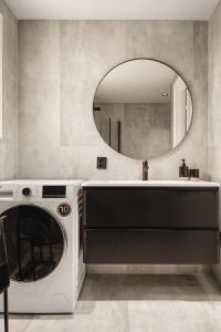 a washing machine in a bathroom with a mirror at Odda View in Odda