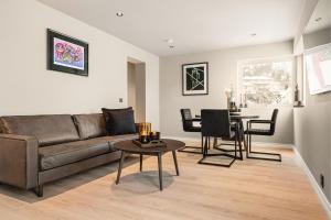 a living room with a couch and a table at Odda View - 4BR & 2BR & 1BR - B11 in Odda