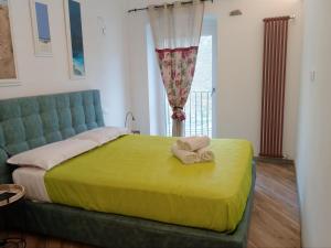 a bedroom with a bed with two towels on it at Il Nido delle Rondini in Levanto +24 photos