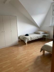 a white room with two beds and a mirror at - SANO Apartments - DGR - Hagen Zentral - Free Parking - WIFI - Washing Machine in Hagen