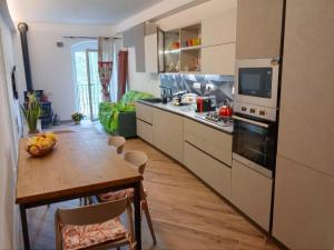 a kitchen with a table and a dining room at Il Nido delle Rondini in Levanto