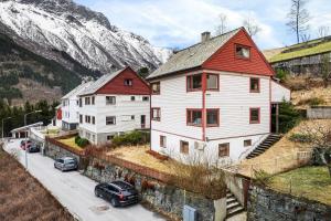 a group of houses on a street with a mountain at Odda View in Odda