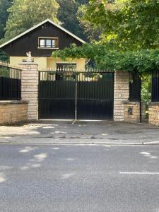 a black gate in front of a house at Comme à la maison ! in Caluire-et-Cuire