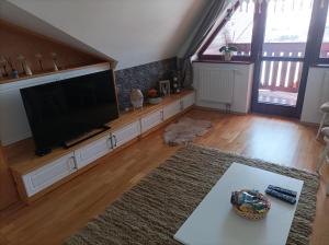 a living room with a large flat screen tv at Apartman Aisha in Veľká Lomnica