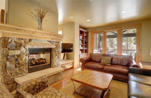 a living room with a couch and a fireplace at 39B Union Creek Townhomes West in Copper Mountain