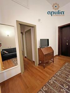 a living room with a couch and a television at Suite Nana by Apulia Accommodation in Bari