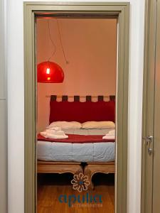 a bedroom with a bed with a red head board at Suite Nana by Apulia Accommodation in Bari