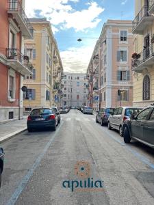 an empty city street with cars parked on the street at Suite Nana by Apulia Accommodation in Bari