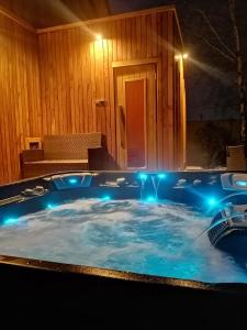 a jacuzzi tub with lights in front of a building at LendHouse - SPA pod Gwiazdami in Sąspów