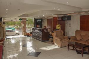 a lobby with chairs and a table in a building at Al Orouba Hotel in Riyadh