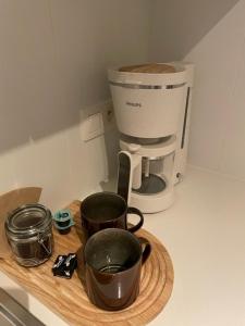 a counter top with a coffee maker and a coffee pot at White Princess - Lehouck in Koksijde