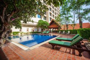 a swimming pool in front of a building at Chiangmai Grandview Hotel & Convention Center in Chiang Mai