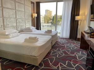 Gulta vai gultas numurā naktsmītnē Grand Hotel Sukhum Resorts
