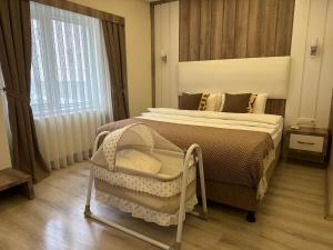 a bedroom with a bed and a large window at Line Suite Hotel in Kırklareli