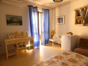 a bedroom with a bed and a desk and a table at Villa Magnolia B&B in Taormina